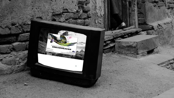 The television shows the Macromedia Dreamweaver splash screen