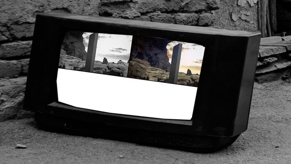 The television splits between black and white and color