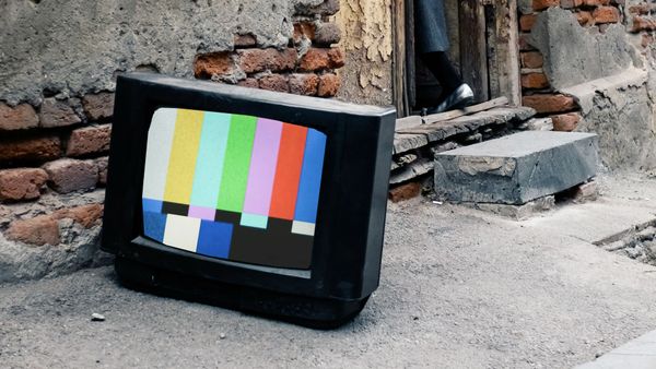 The television screen shows a color bars test pattern