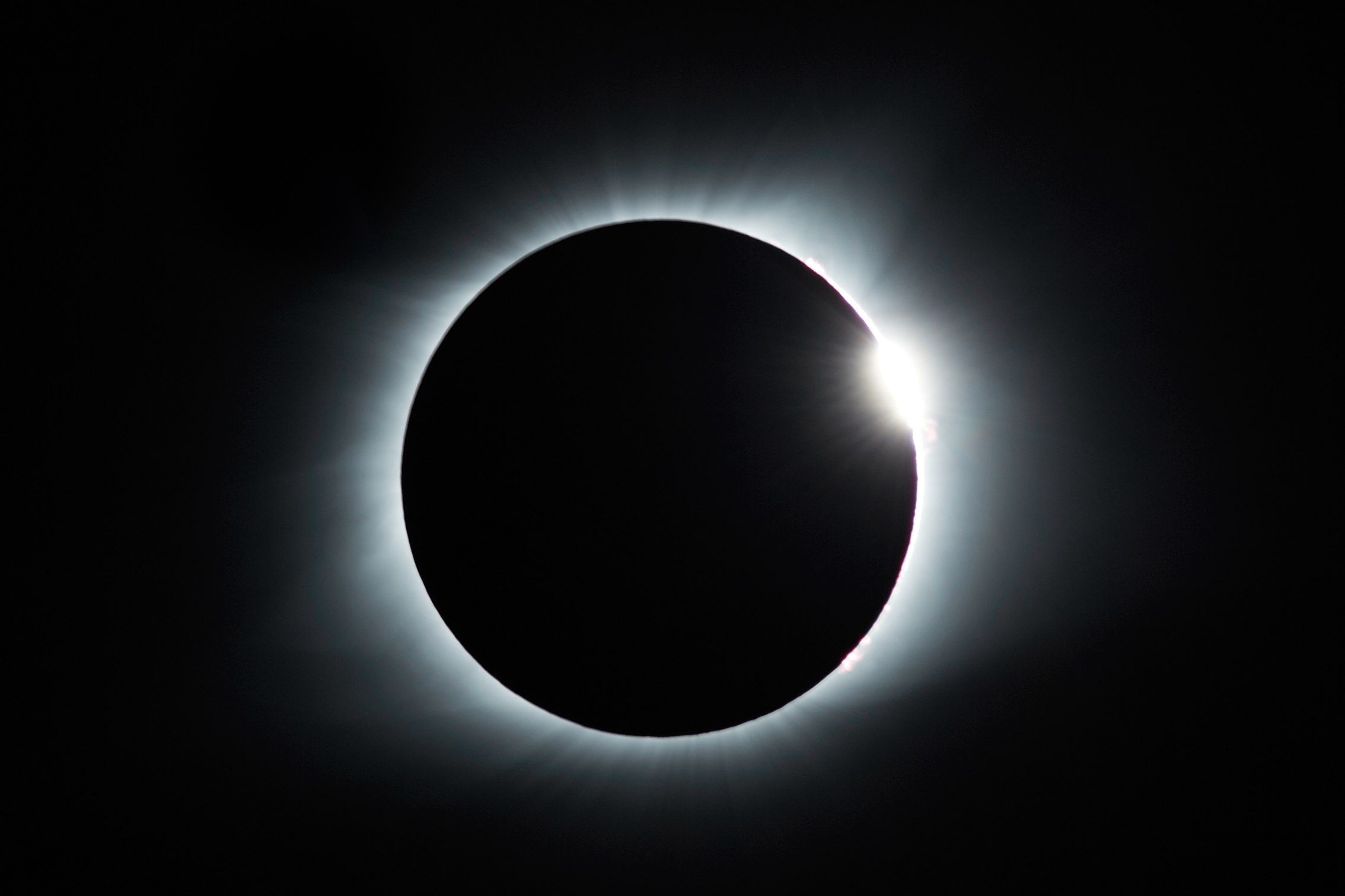 Total solar eclipse with the sun’s corona glowing around the moon