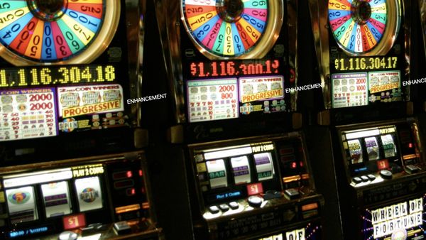 A row of Wheel of Fortune slot machines labeled PROGRESSIVE ENHANCEMENT